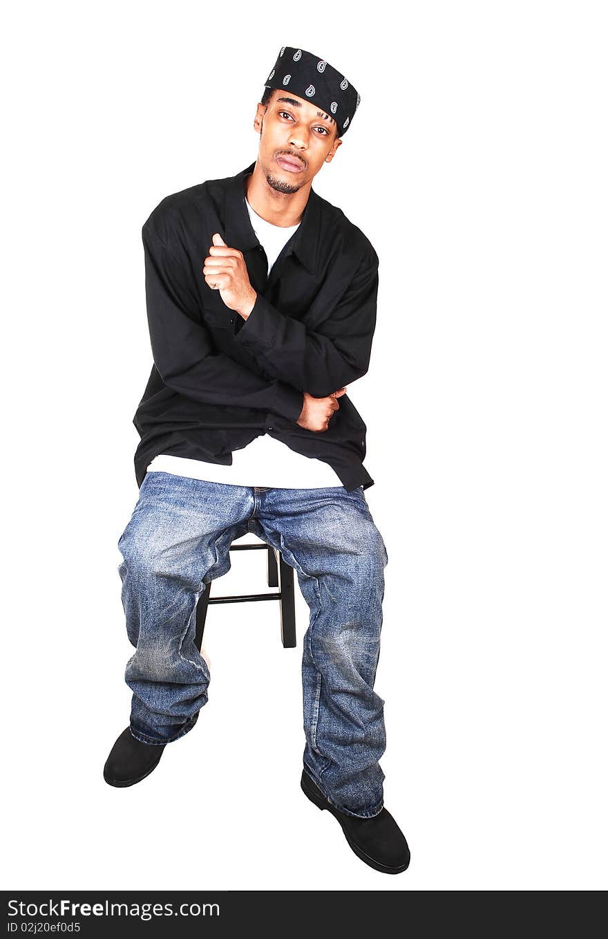 A black man in jeans, way down, and very big and long shirt, with a headscarf,
sitting in the studio, for light blue background. A black man in jeans, way down, and very big and long shirt, with a headscarf,
sitting in the studio, for light blue background.