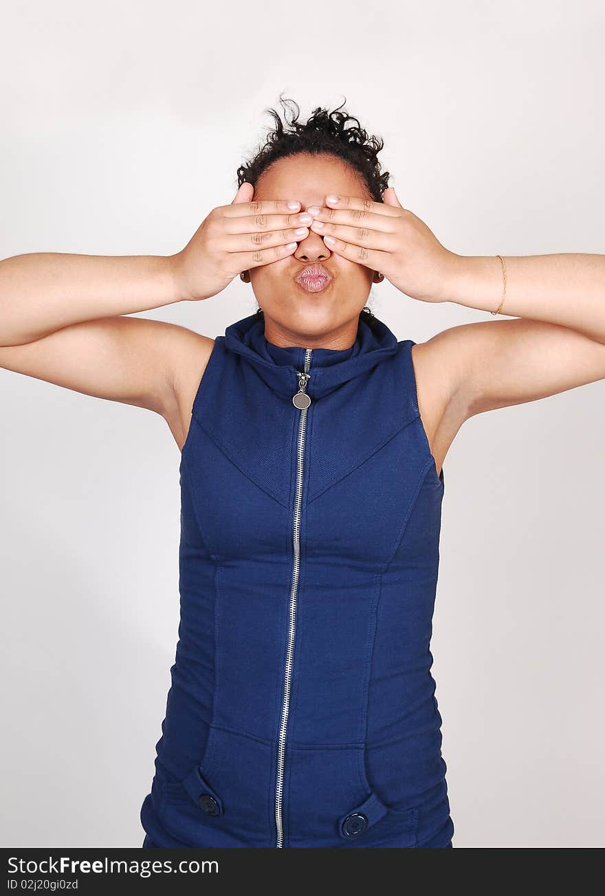 A young Hispanic girl standing in a and covering her eyes
with her hands, in a blue dress with a zipper in front, for white background. A young Hispanic girl standing in a and covering her eyes
with her hands, in a blue dress with a zipper in front, for white background.