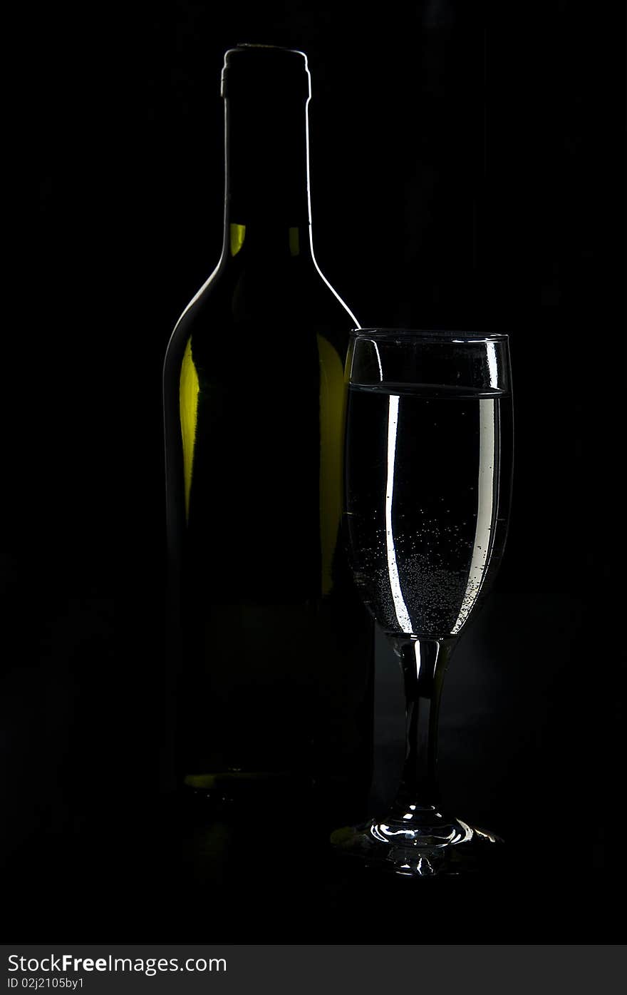 Shot glass of wine and a black background