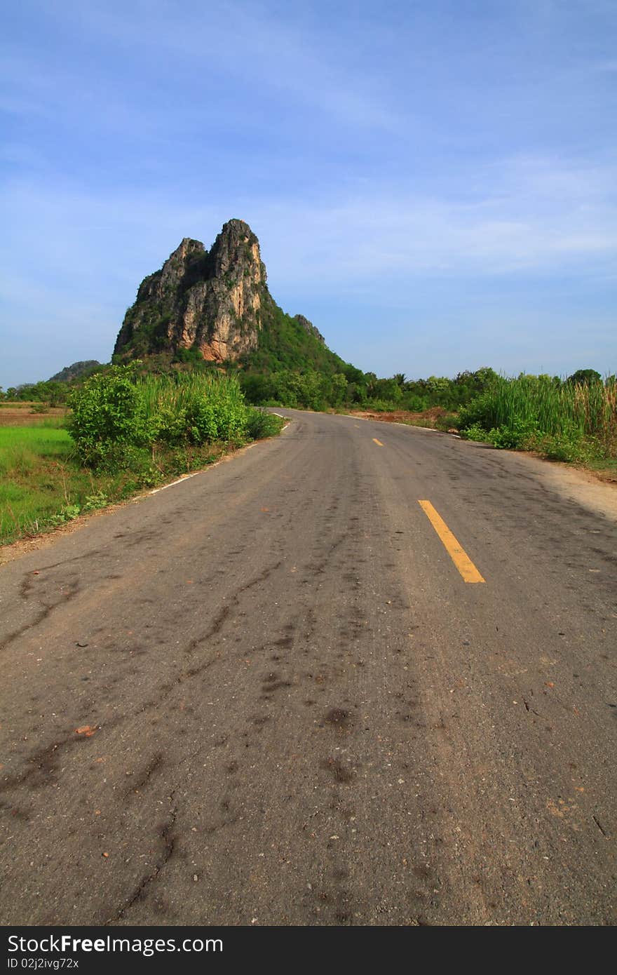 This rural road straight to big mountain with blue sky. This rural road straight to big mountain with blue sky.