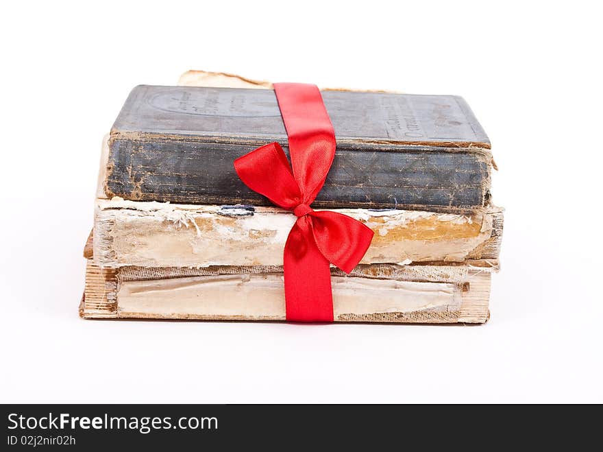 Pile of books with red ribbon and bow