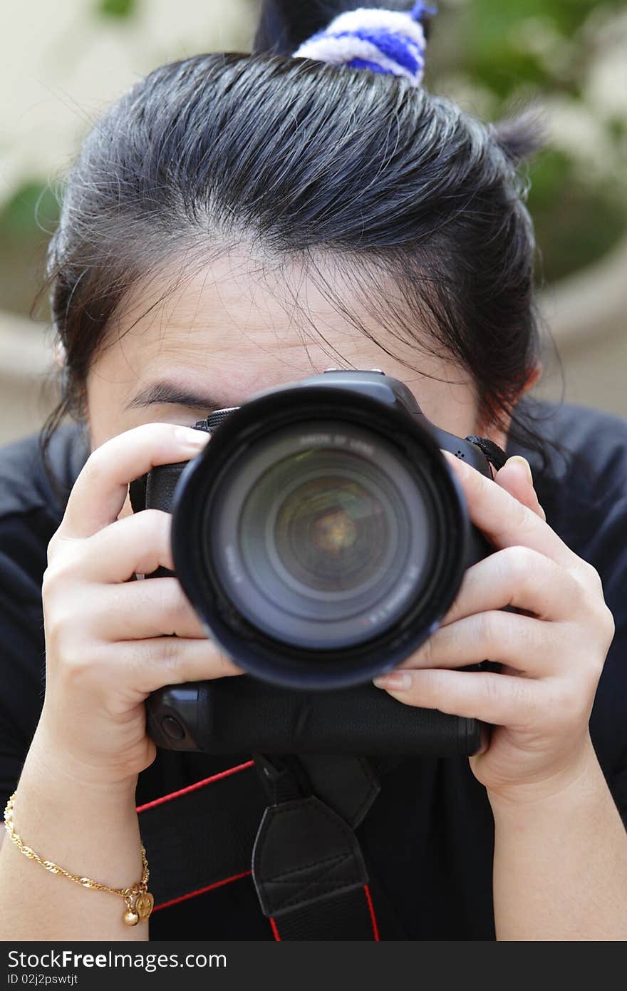 A female photographer taking photos with a camera