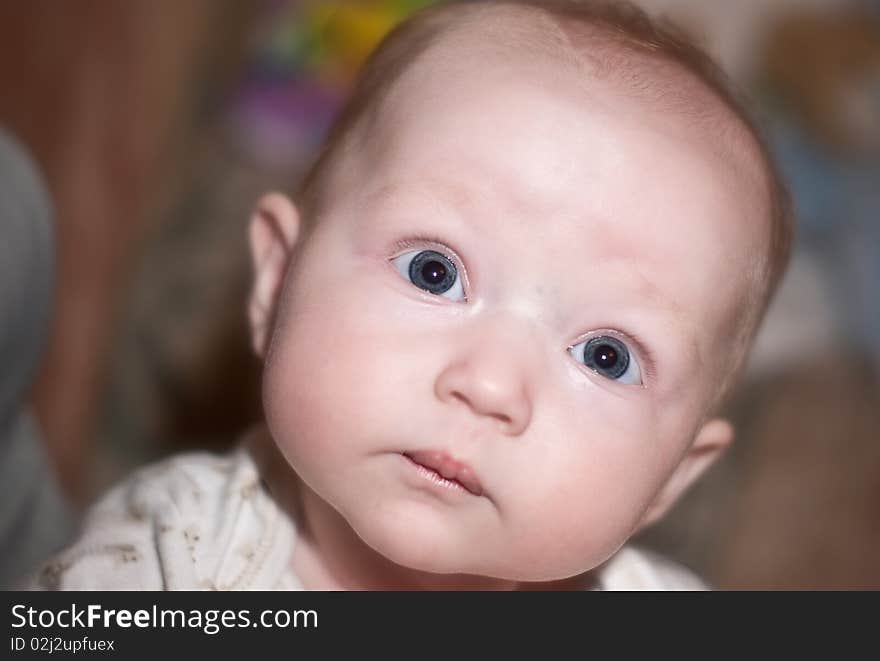 Close up photo of a beautiful baby girl with blue eyes