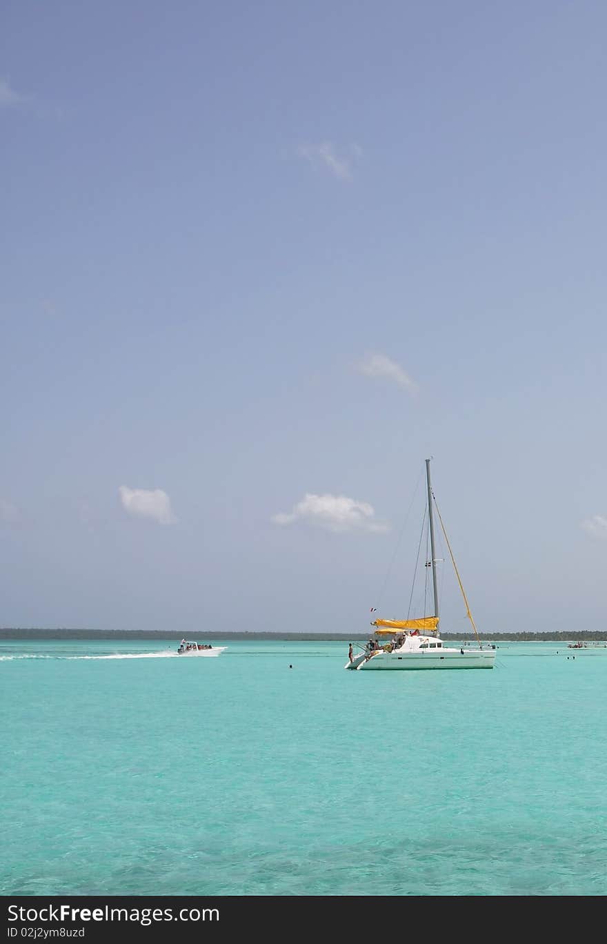 Catamarana and people swiming in caribbean sea