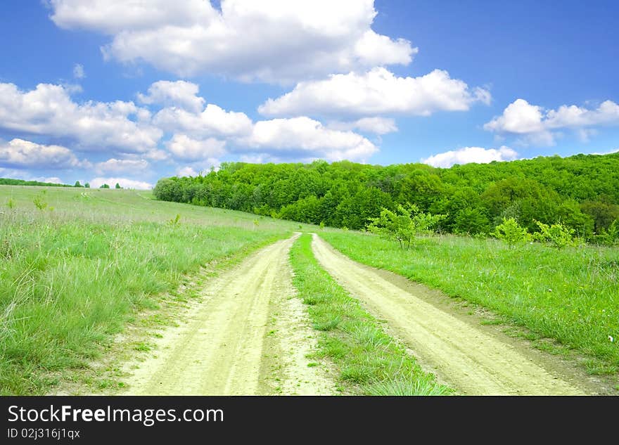 Earthen road in the middle of field. Earthen road in the middle of field