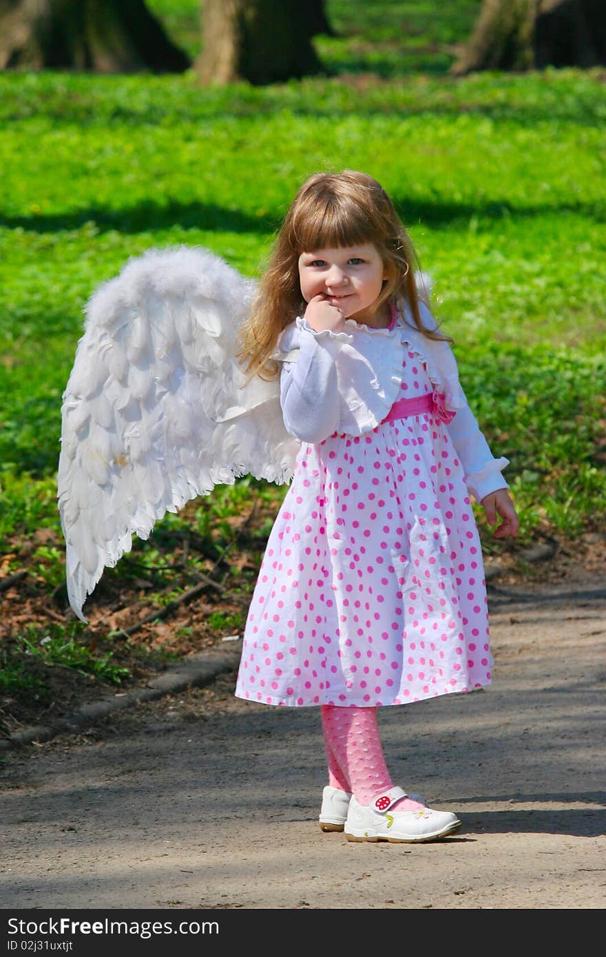 Young girl with wings in park