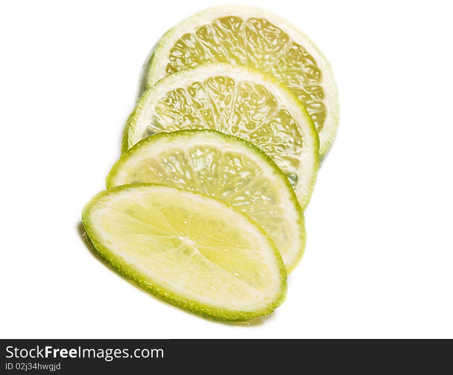 Fresh green lime fruit towards white background