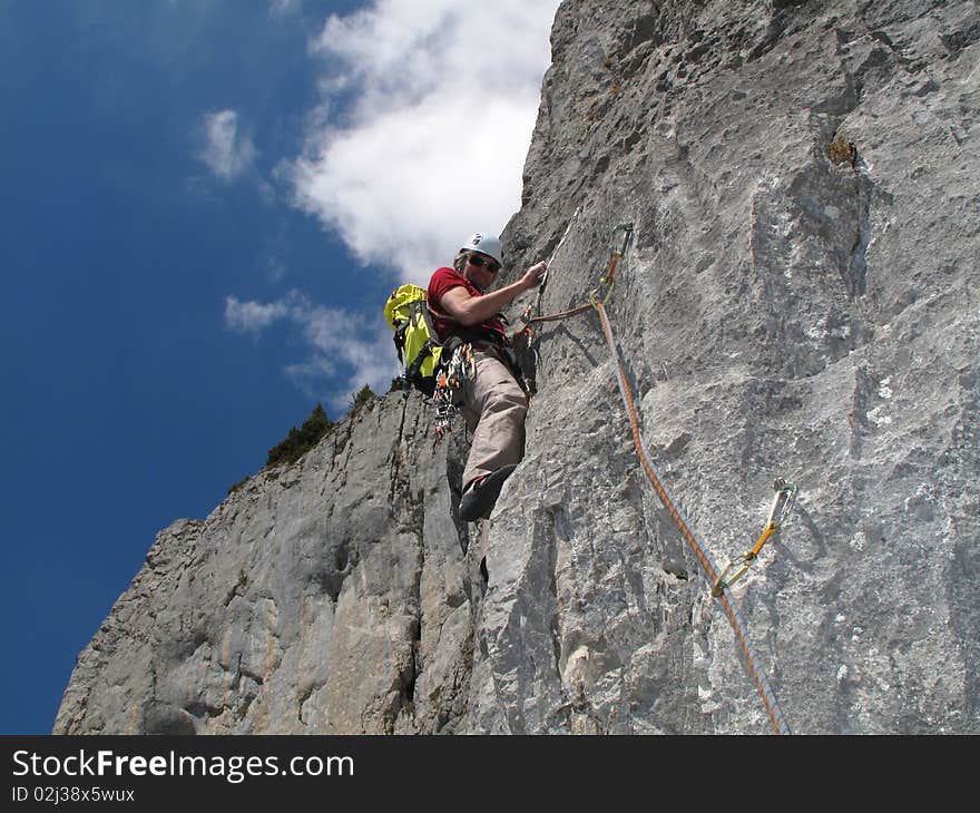 Climber on a very sunny day; Sandmeierrippe, Simmental, Mittagflue, Switzerland. Climber on a very sunny day; Sandmeierrippe, Simmental, Mittagflue, Switzerland