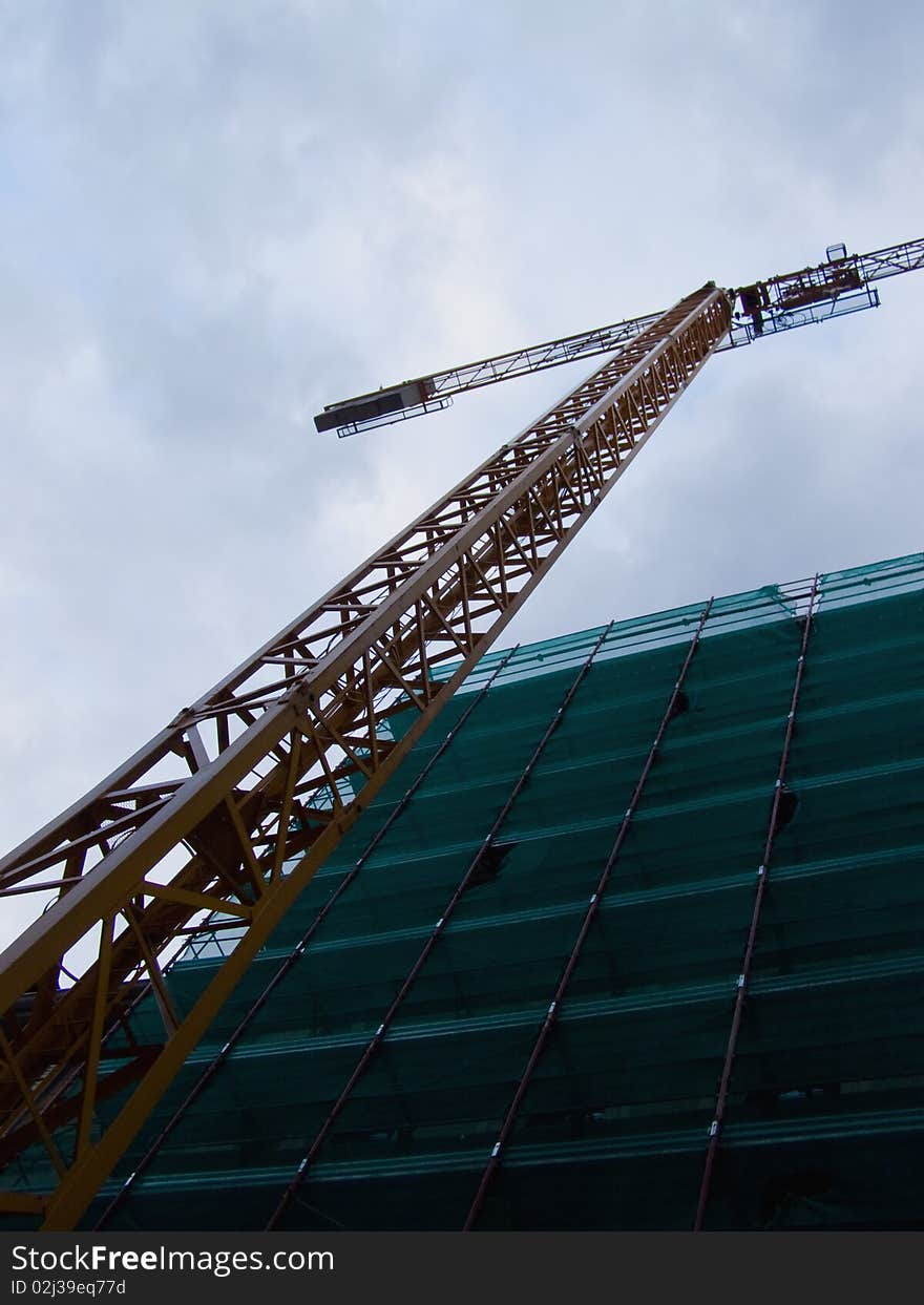 Crane working against cloudy sky on a residential building site 

*with space for text (copyspace)
**RAW format available at request. Crane working against cloudy sky on a residential building site 

*with space for text (copyspace)
**RAW format available at request