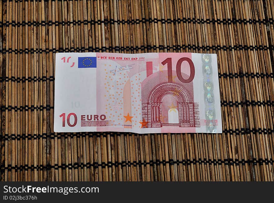 Ten Euro currency on bamboo background