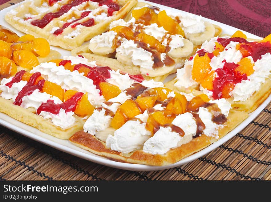 Homemade wafle with mandarin and caramel icing