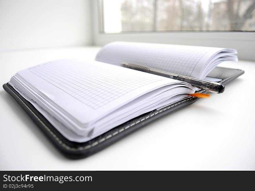 Open notebook with the handle, on white background.