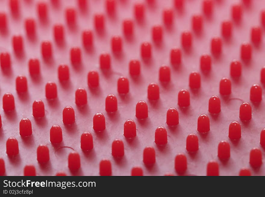 Red plastic pattern background macro shot (blurred background)