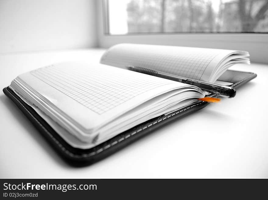 Open notebook with the handle, on white background.