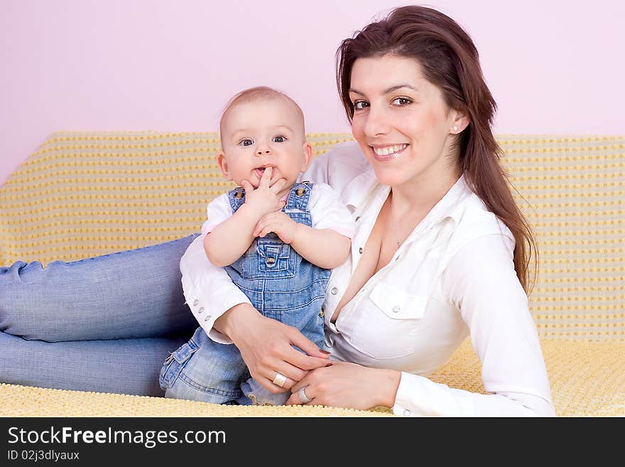 Mother plays with babygirl on bed. Mother plays with babygirl on bed