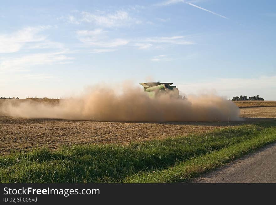 Dust from a combine fills the air. Dust from a combine fills the air