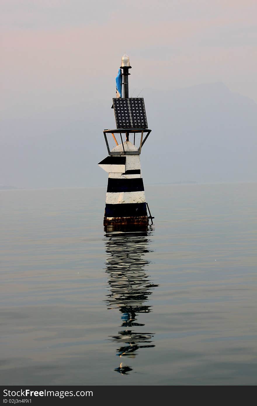 Beacon with the Madonna in lake