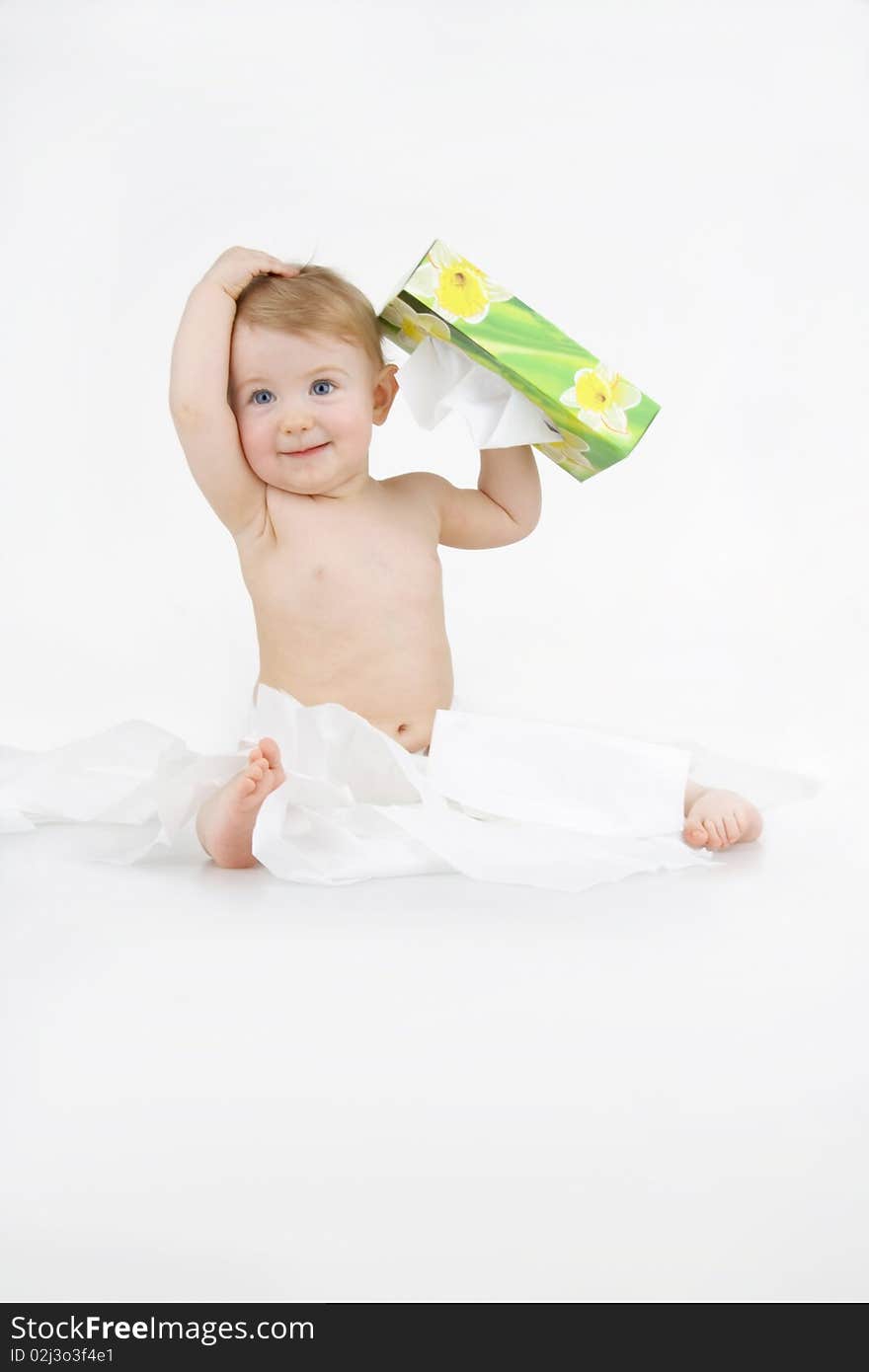 Infant plaies with box napkin on egg white background. Infant plaies with box napkin on egg white background.