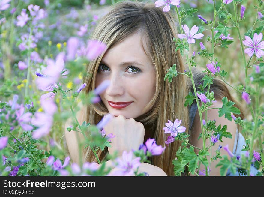 Portrait of happy girl in violet flowers. Portrait of happy girl in violet flowers