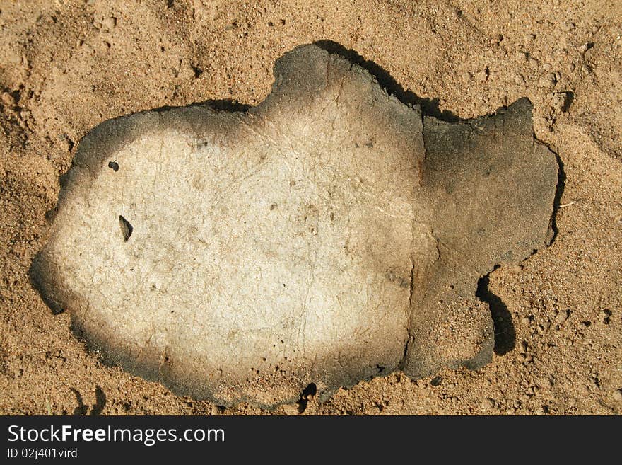 Deification of old paper on the sand. Deification of old paper on the sand