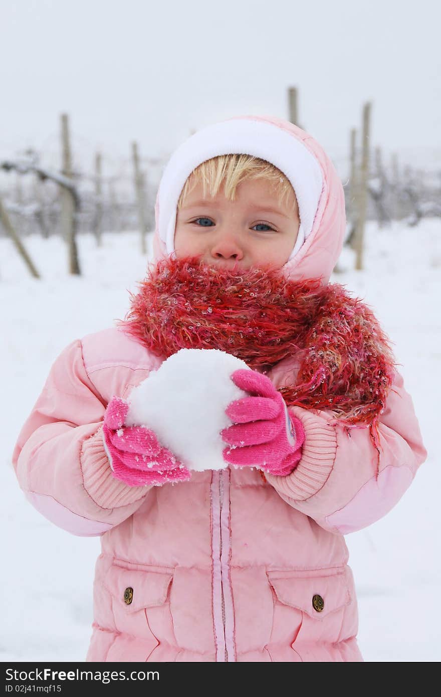 Pretty girl making a snowball