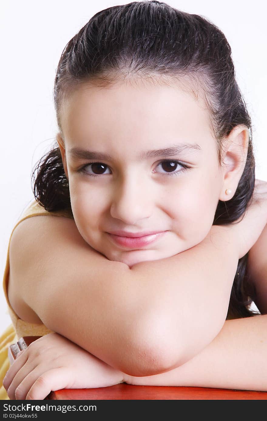 Smiling girl looking at the camera over white background.