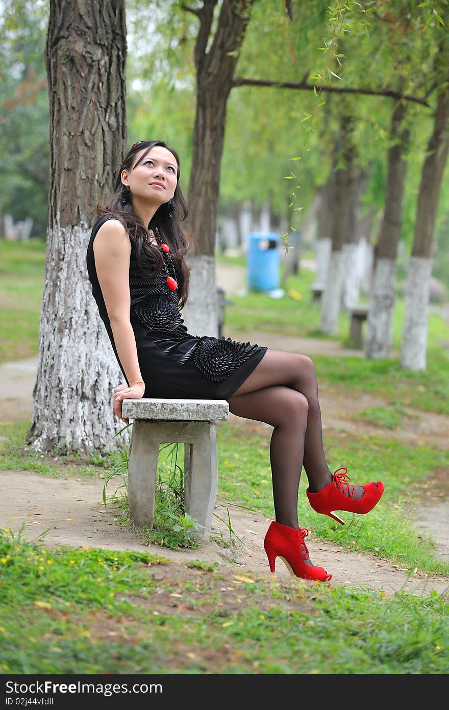 Asian woman sit in Chair with  High-heeled shoes.