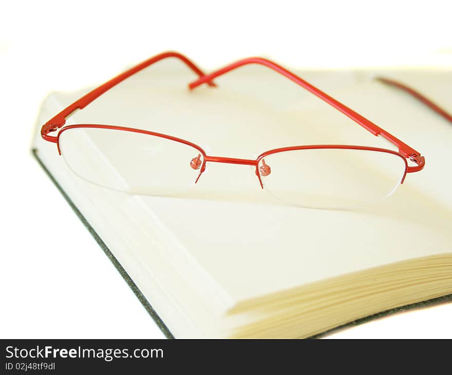 Notebook made of a red skin and glasses. Photo taken on May 10th,2010.