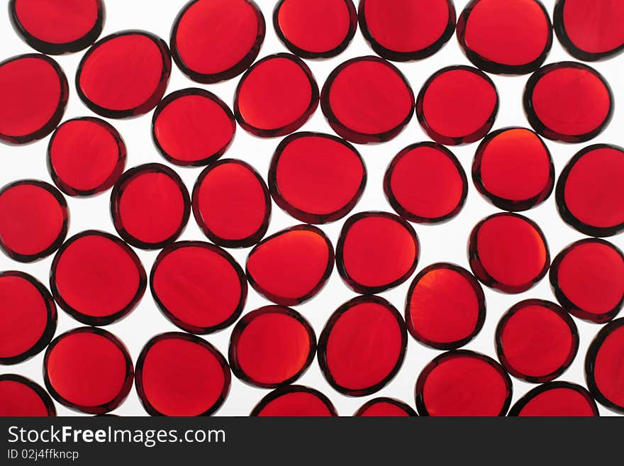 Red fragments of glass on a white background. Red fragments of glass on a white background