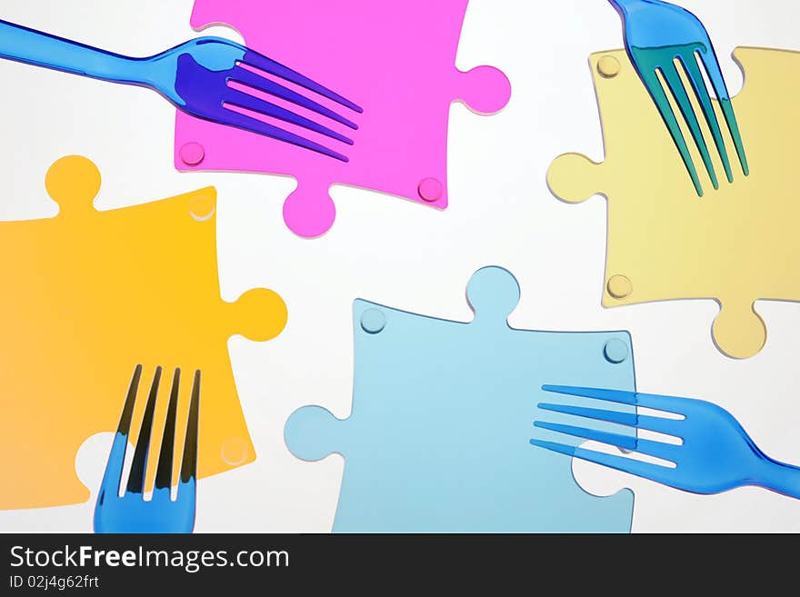 Dark blue plugs and multi-coloured elements of a puzzle on a white background. Dark blue plugs and multi-coloured elements of a puzzle on a white background