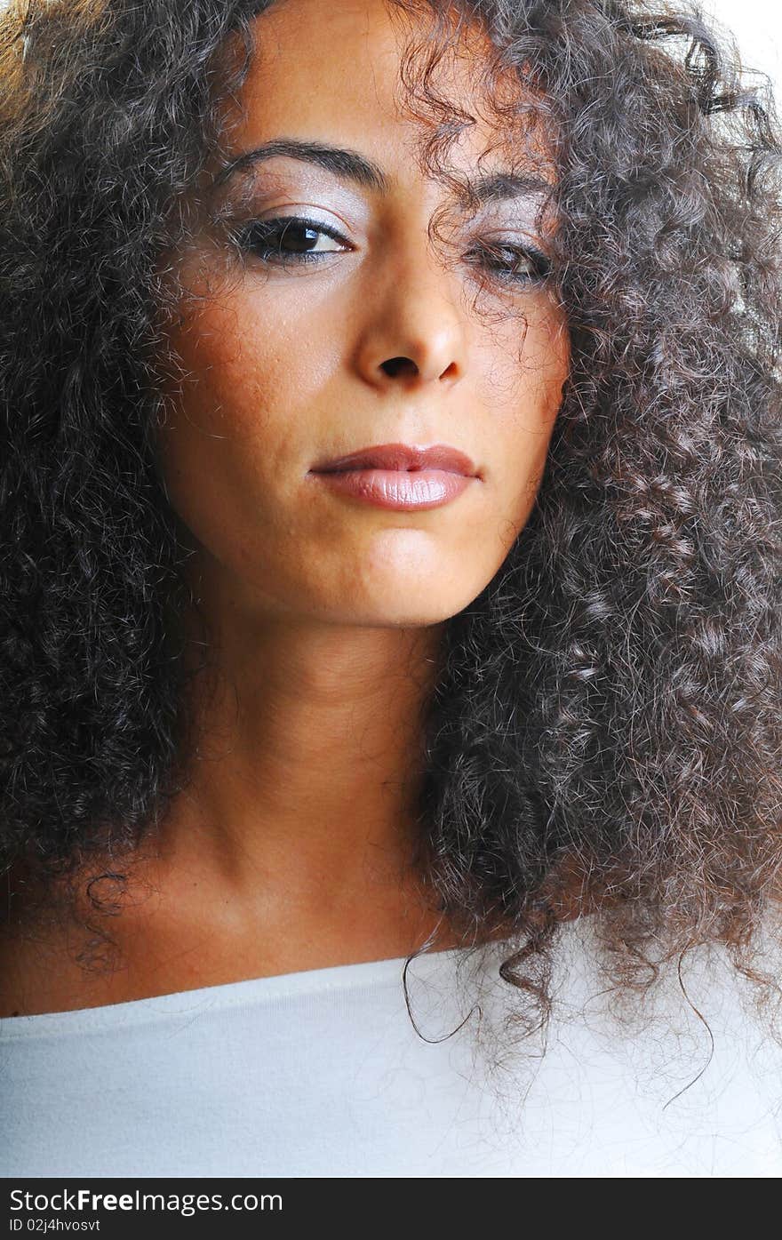 Portrait of beautiful woman with curly hairs.