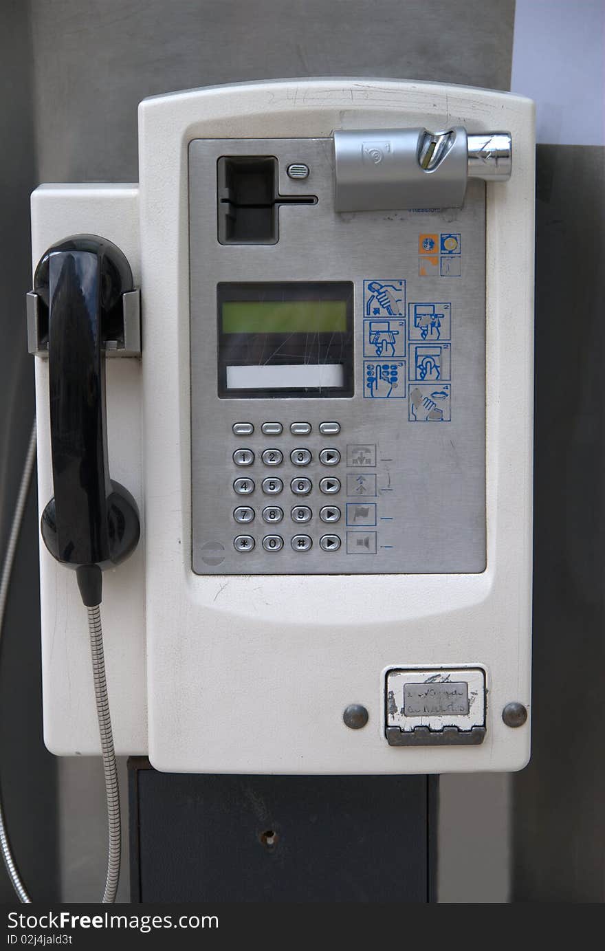 Coin and credit card operated public phone