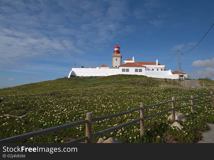 Lighthouse and adjacent buildings on a hill top