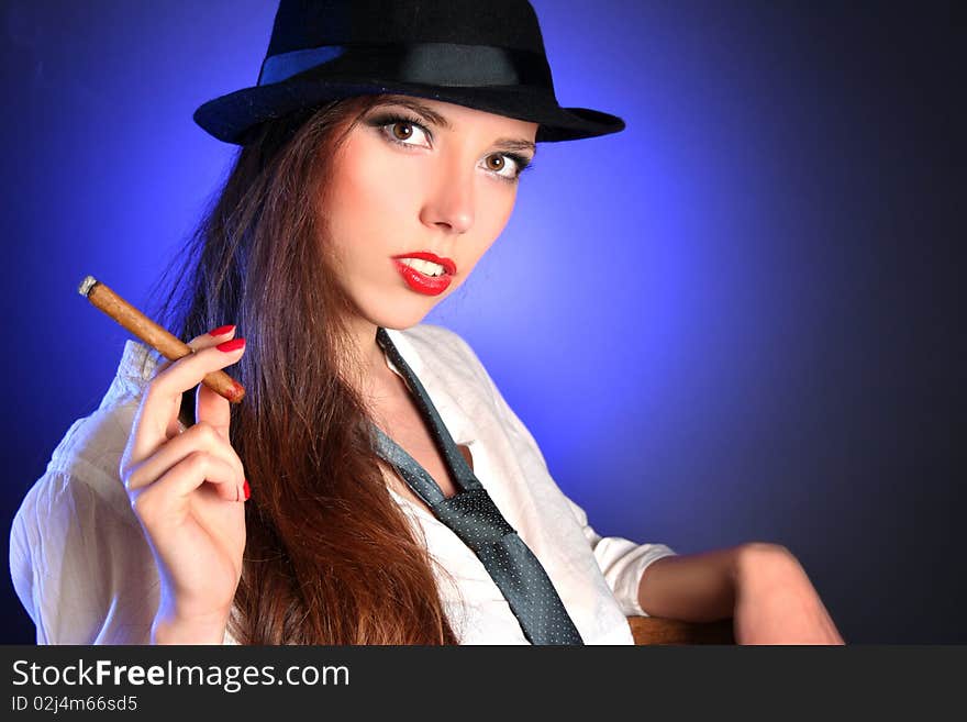 Beautiful young woman smoking cigar. Beautiful young woman smoking cigar