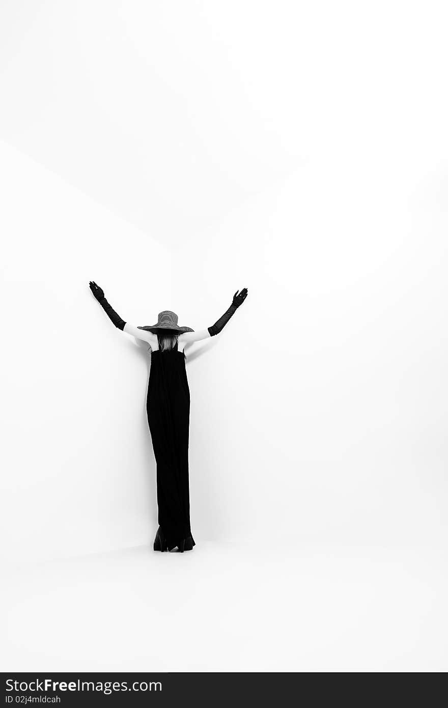 Portrait of a beautiful girl in elegant black dress and a hat. Portrait of a beautiful girl in elegant black dress and a hat.