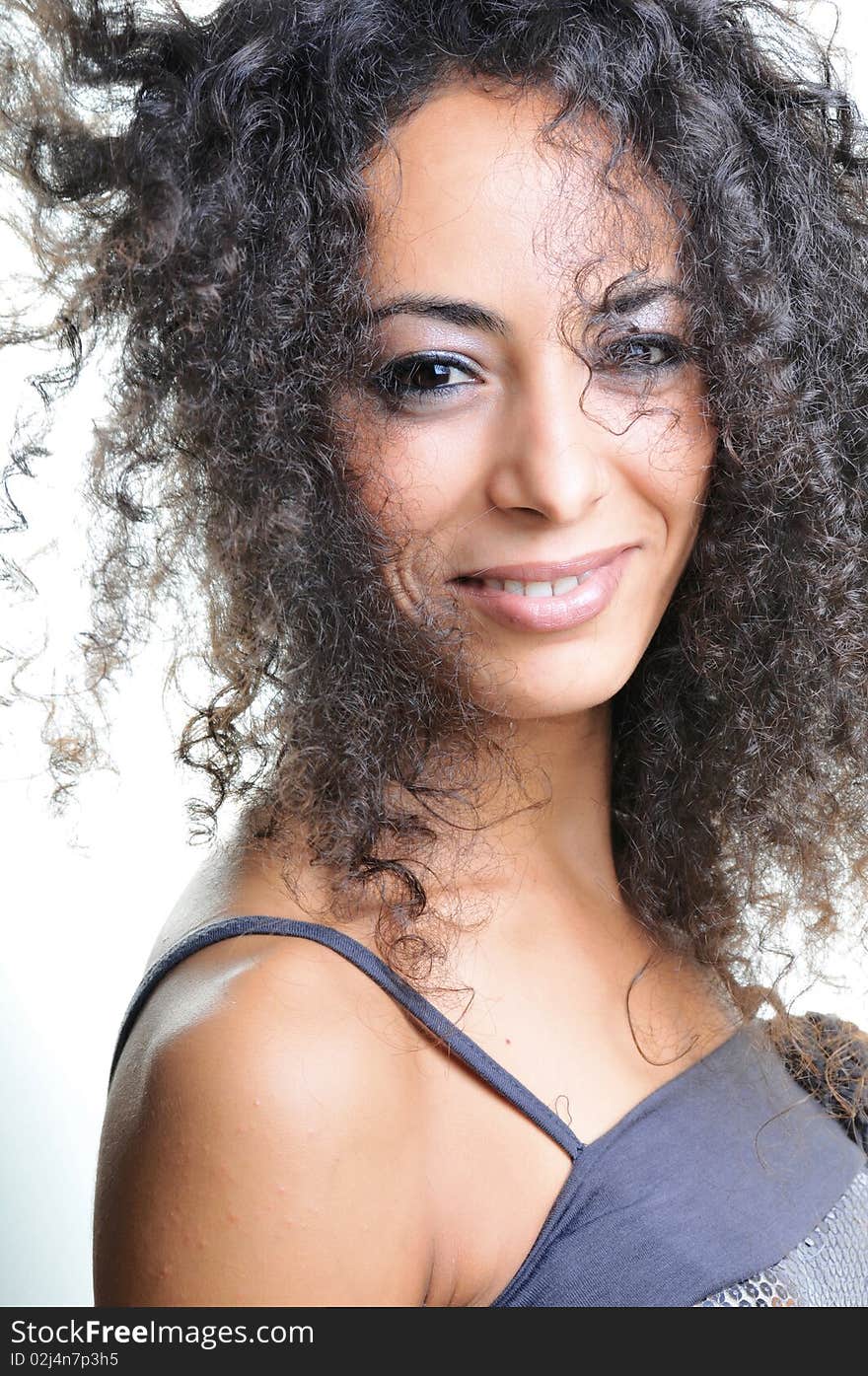 Portrait of beautiful woman with curly hairs.