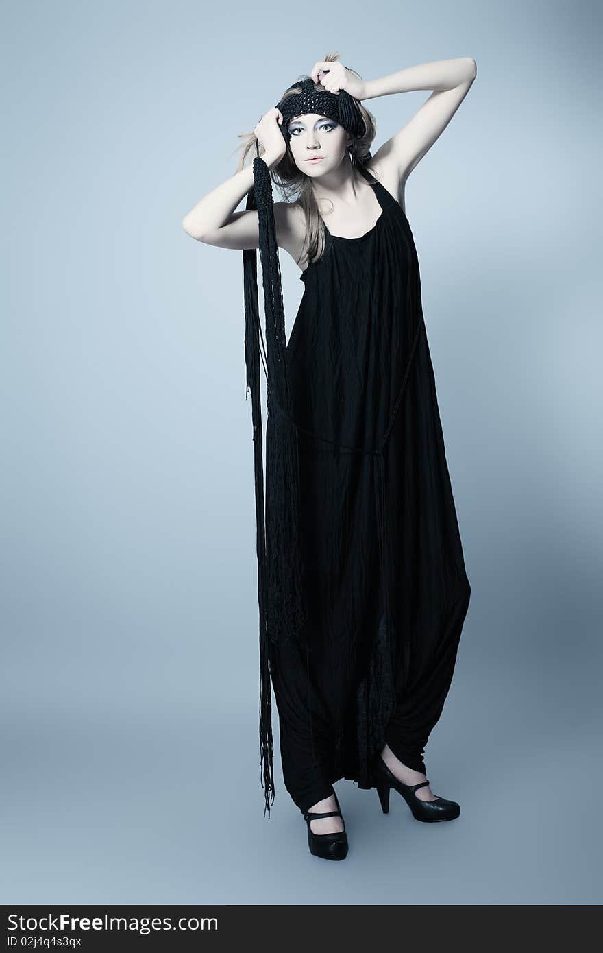 Portrait of a beautiful girl in elegant black dress. Shot in a studio. Portrait of a beautiful girl in elegant black dress. Shot in a studio.