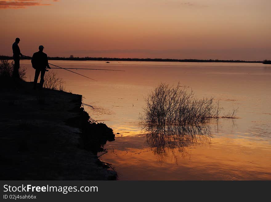 Silhouette of Fishermen on a sunset