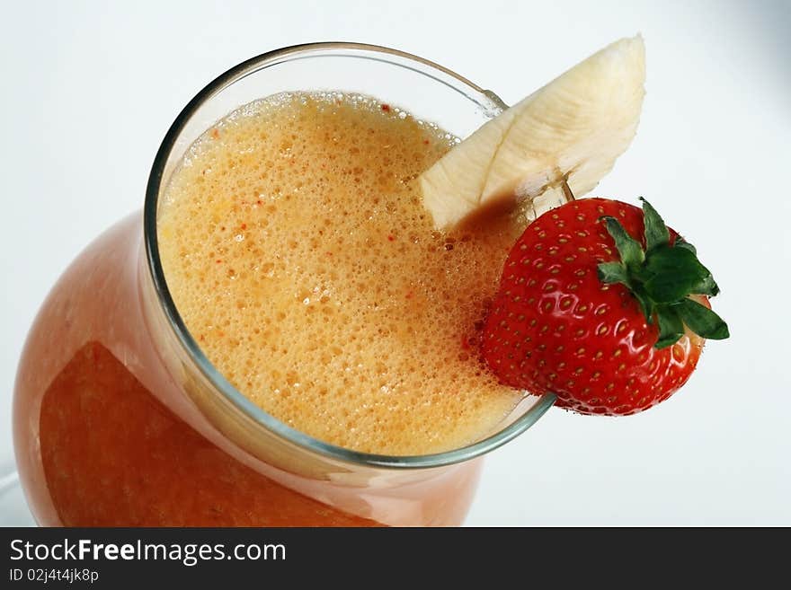 Banana and strawberry smoothies. Close-up on a grey background. Banana and strawberry smoothies. Close-up on a grey background.