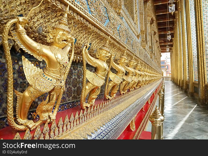 The statue garuda fairy tale animal of thai buddhist native on the temple wall at wat prokeaw temple in bangkok province, metropolis of Thailand. The statue garuda fairy tale animal of thai buddhist native on the temple wall at wat prokeaw temple in bangkok province, metropolis of Thailand