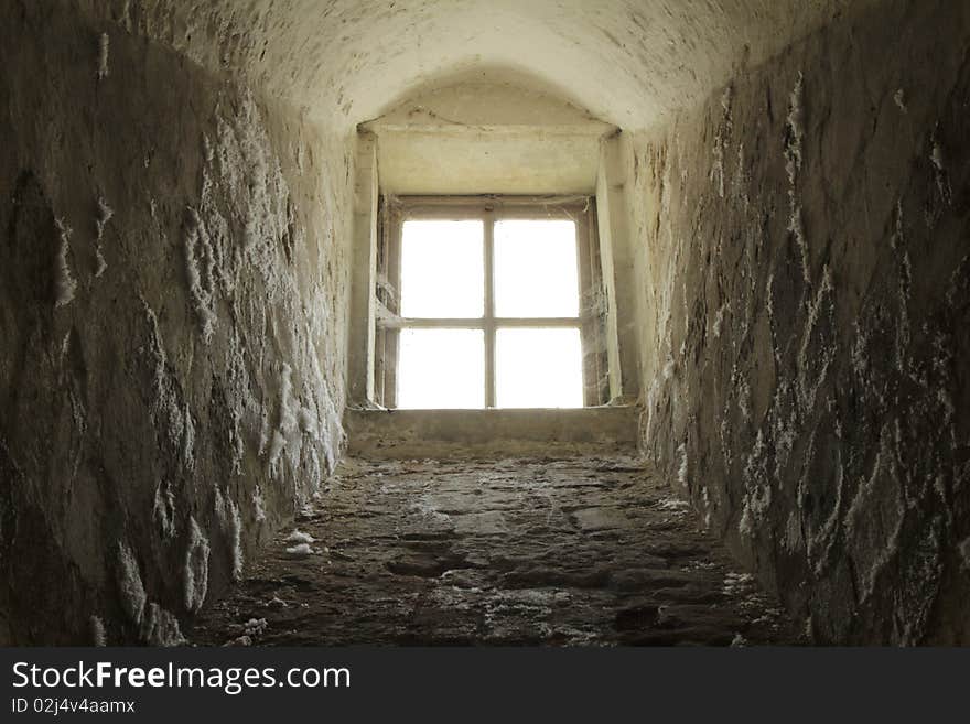 Castle basement window with light flooding in