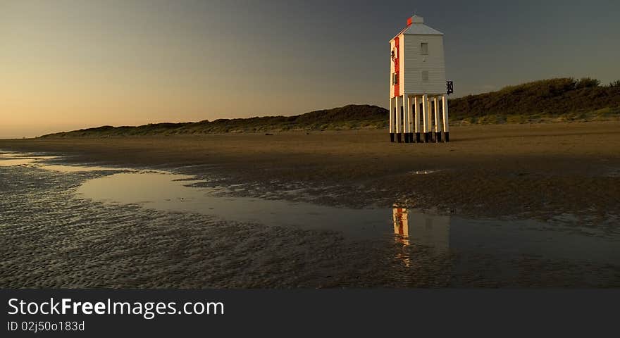 Beach scene with lighthouse