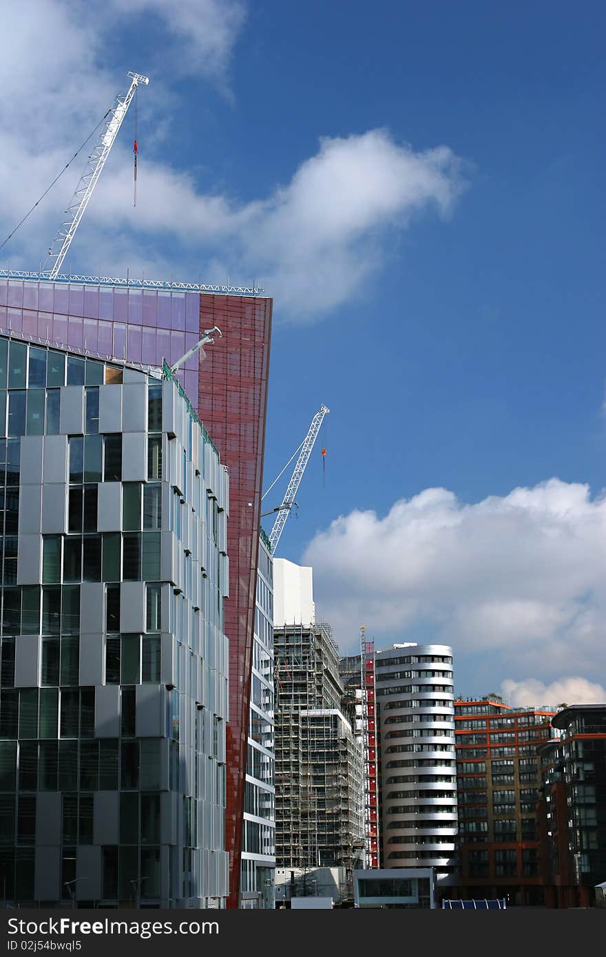 Modern buildings along the Paddington bassin in London with cranes. Modern buildings along the Paddington bassin in London with cranes