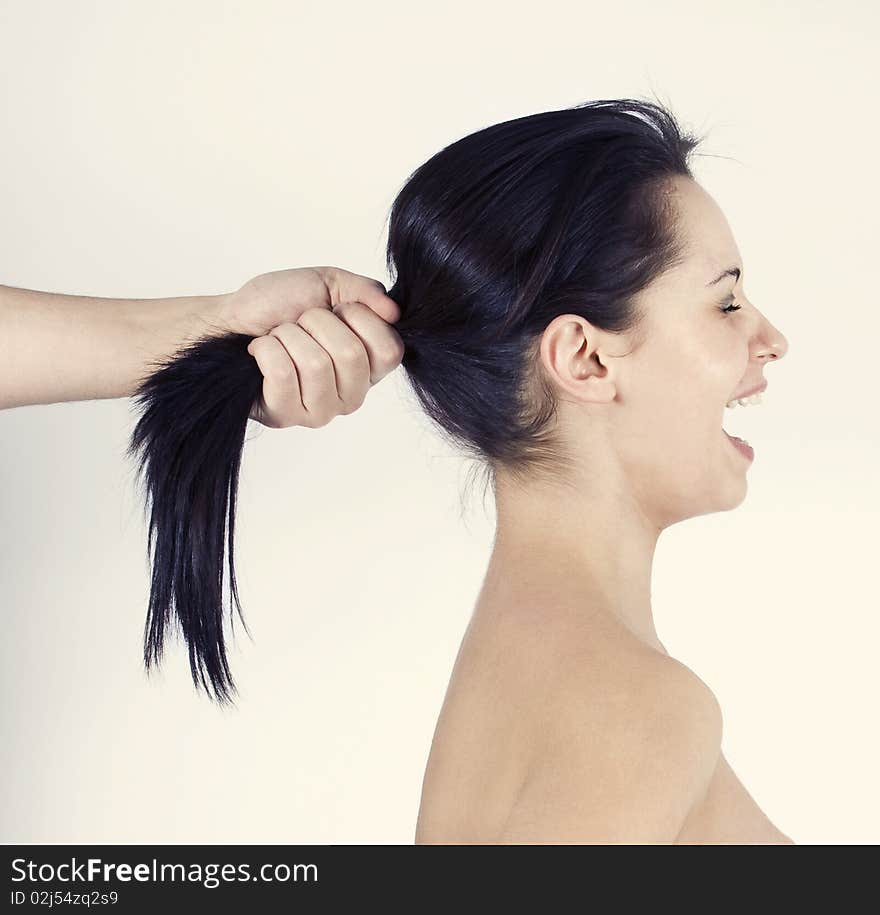 Girl yelling because her hair is pulled. Girl yelling because her hair is pulled