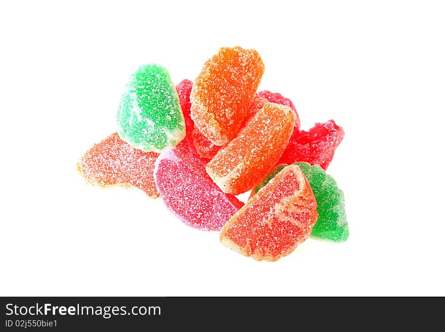 Fruit sweets of orange, green and red colour on a white background.