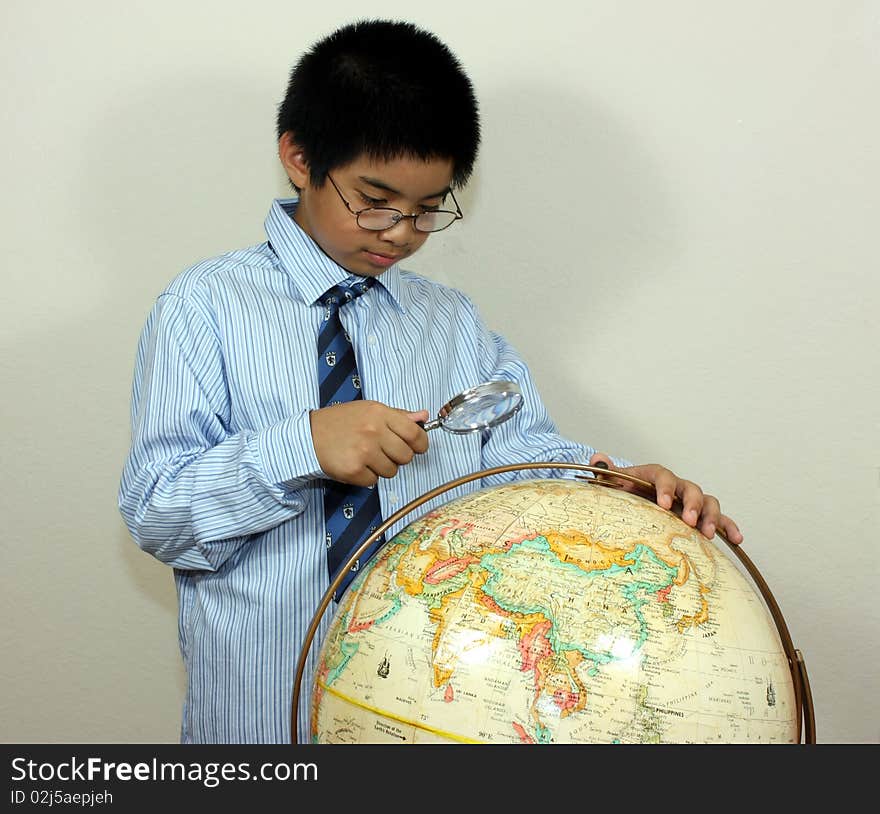 A boy examining a globe