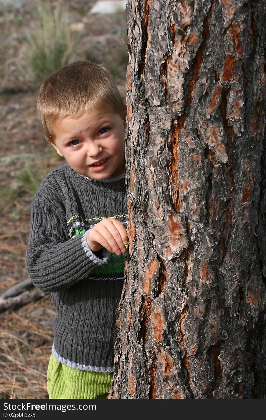 Beautiful blond boy playing outdoors on a spring day