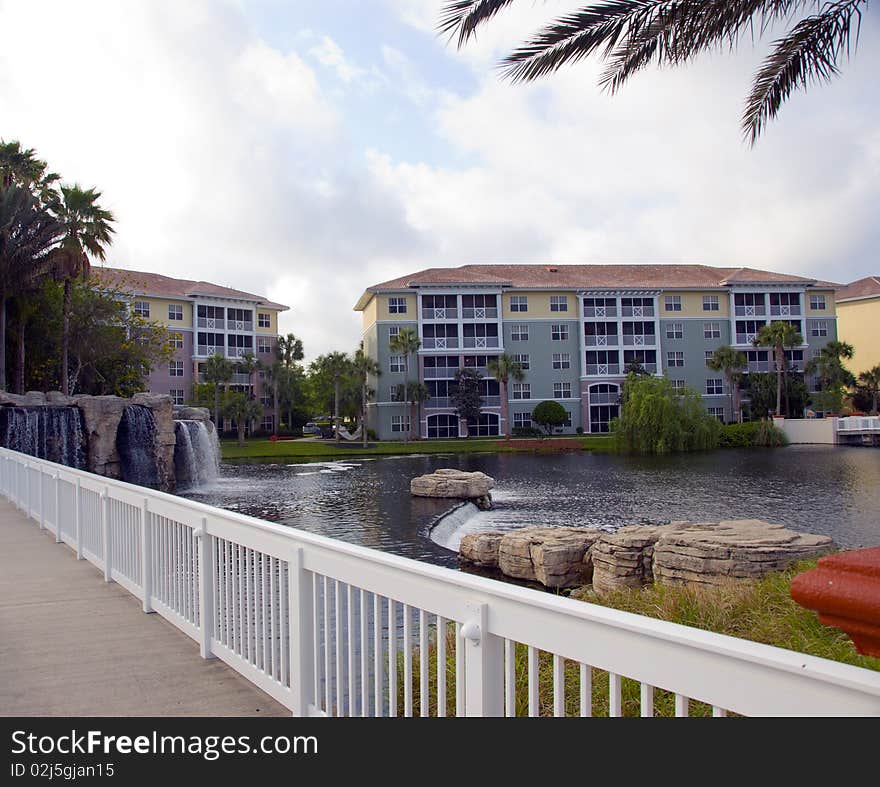 Waterfront condo living in tropical setting with palm trees, bridge and water. Waterfront condo living in tropical setting with palm trees, bridge and water