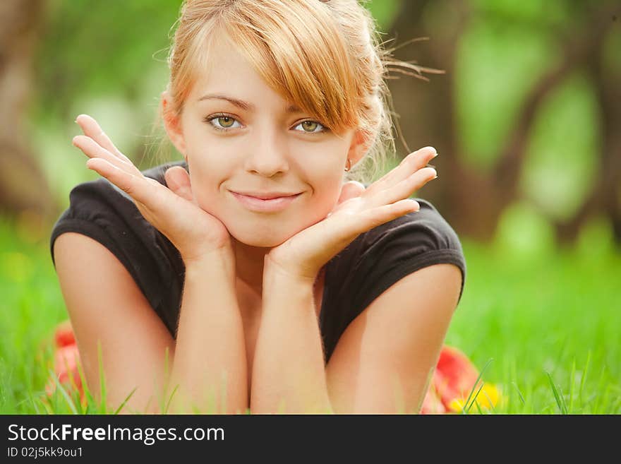 Young pretty girl lying on green grass. Young pretty girl lying on green grass