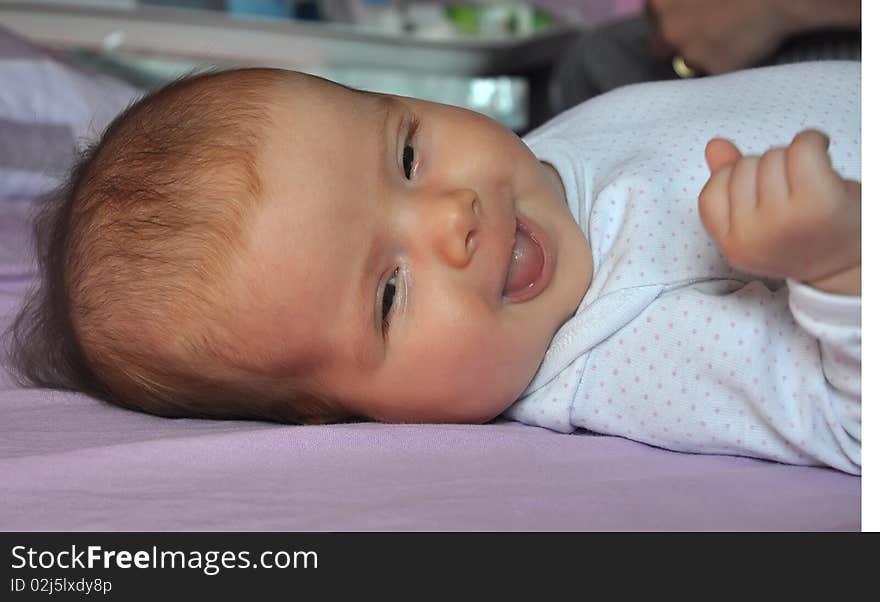 Two months old baby girl showing tip of tongue